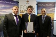photo showing Mr Cretney MLC (centre), Member of DEFA, presenting the BRC AA certification to Allan Skillicorn, Chairman of Isle of Man Meats (right) and Mike Owen, Chief Executive.