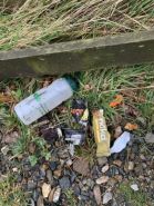 Litter left in a plantation (3 Pieces of Plastic)
